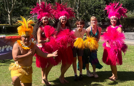 Students posing with Polynesian dancers